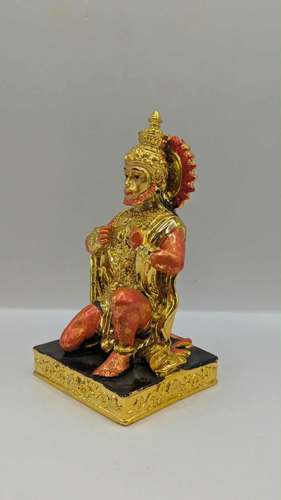 Gold and orange kneeling Hanuman resin statue, other side view