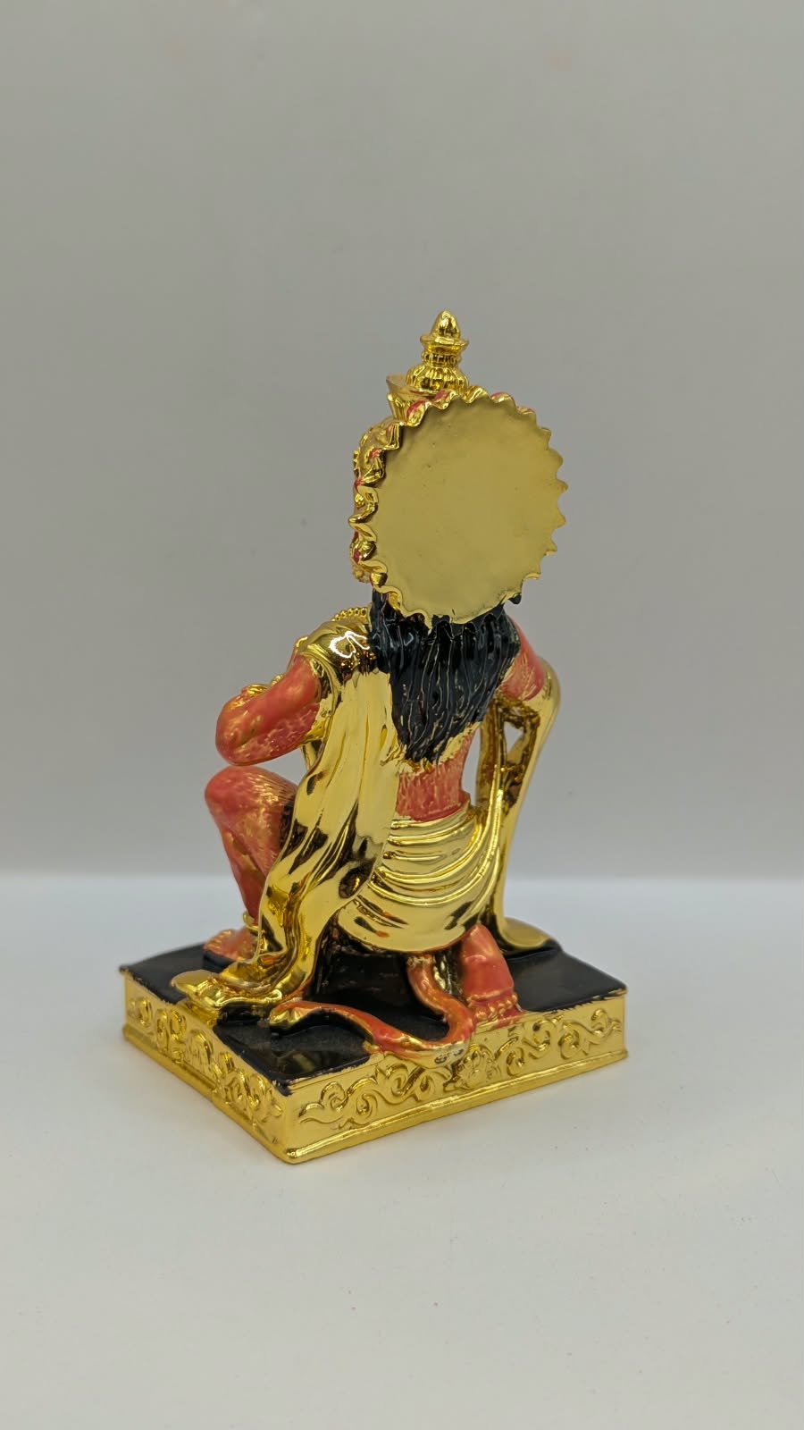 Gold and orange kneeling Hanuman resin statue, back view