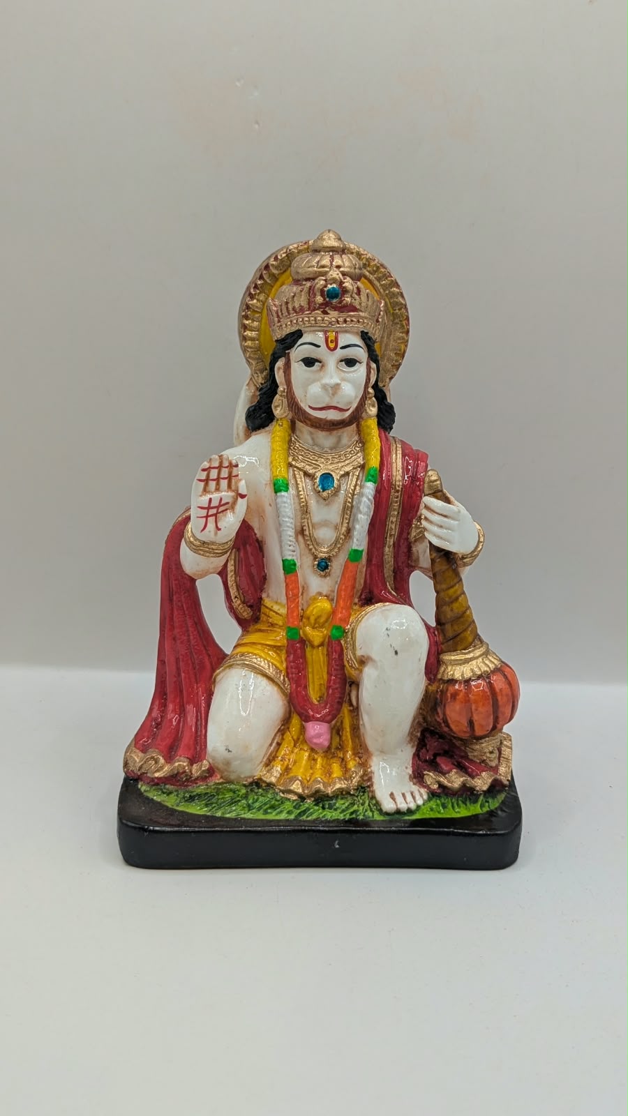 White and red kneeling Hanuman resin statue, front view