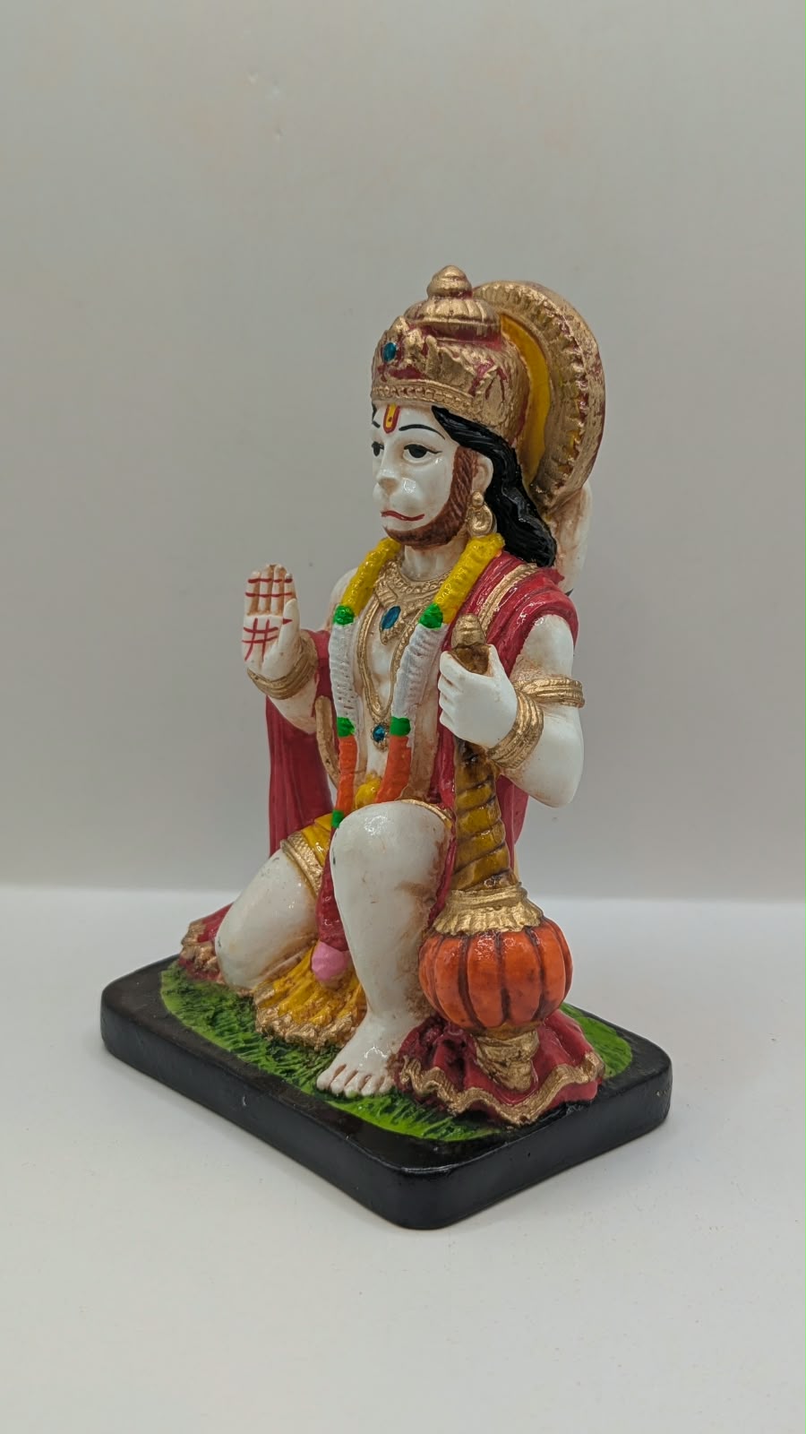 White and red kneeling Hanuman resin statue, other side view