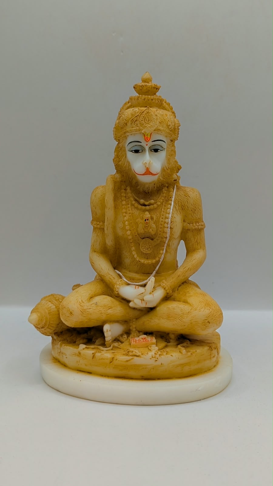 Cream meditating Hanuman resin statue, front view
