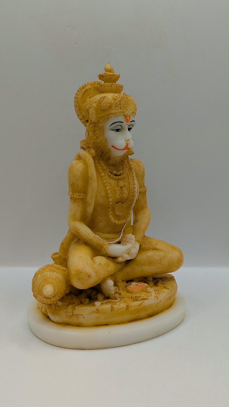 Cream meditating Hanuman resin statue, side view