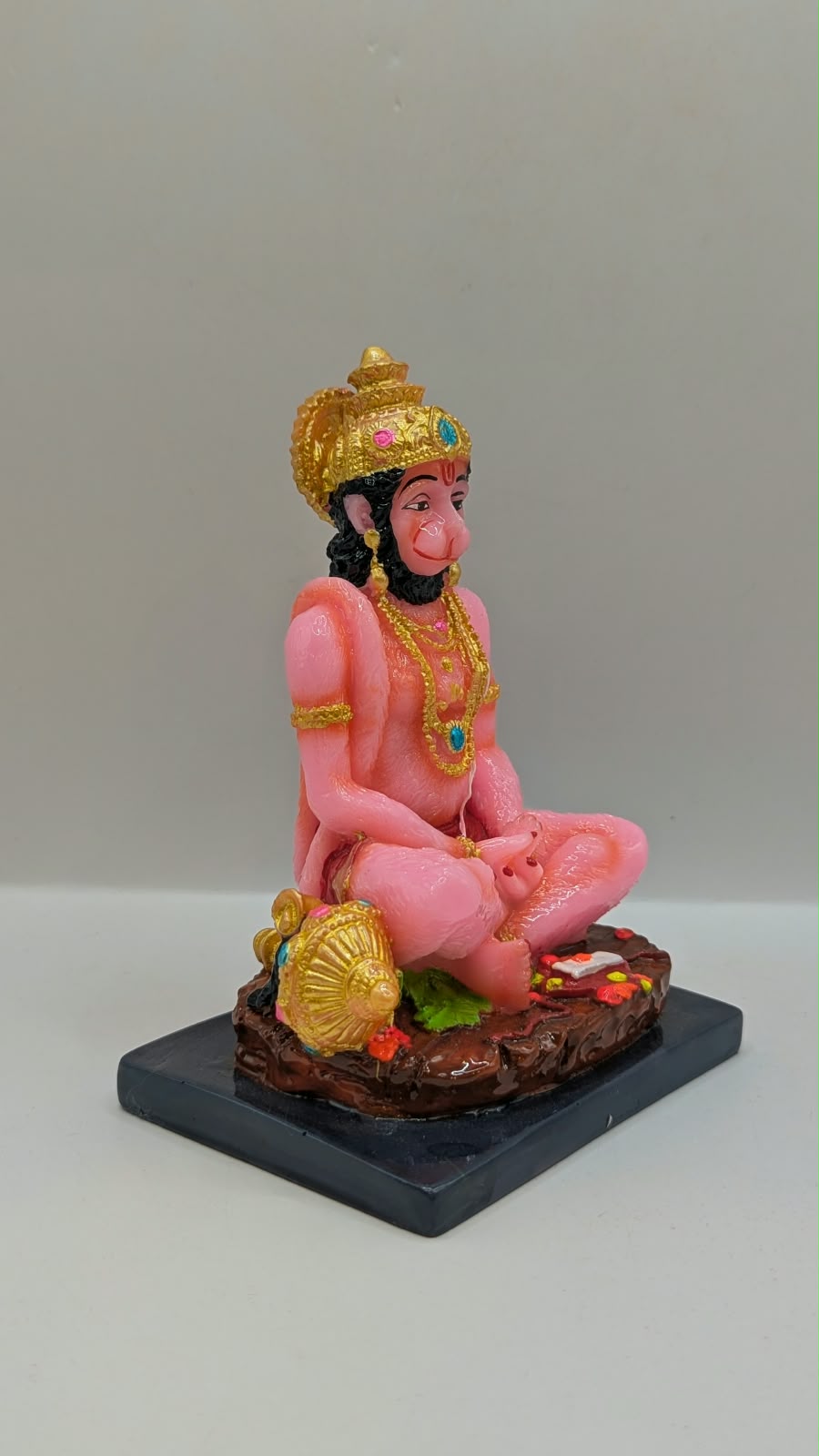 Pink meditating Hanuman resin statue, side view