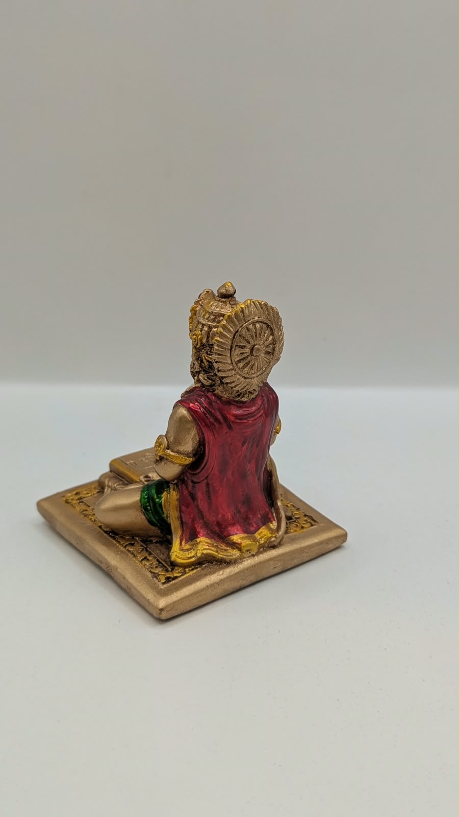 Gold and maroon Hanuman reading Ramayan resin statue, back view