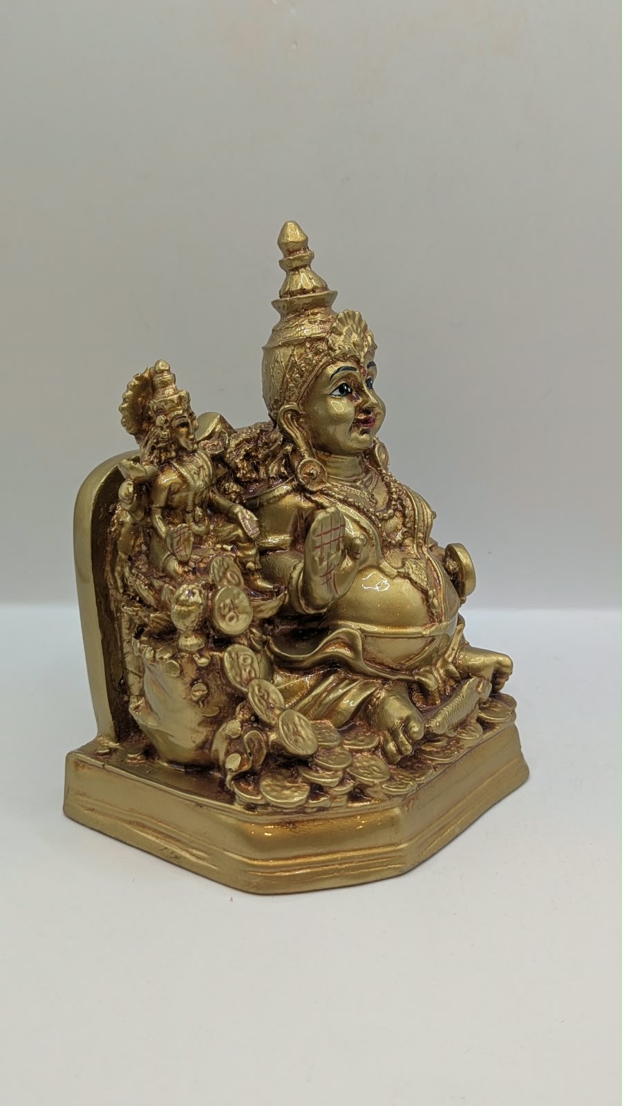 Gold Kuber statue with Laxmi, side view