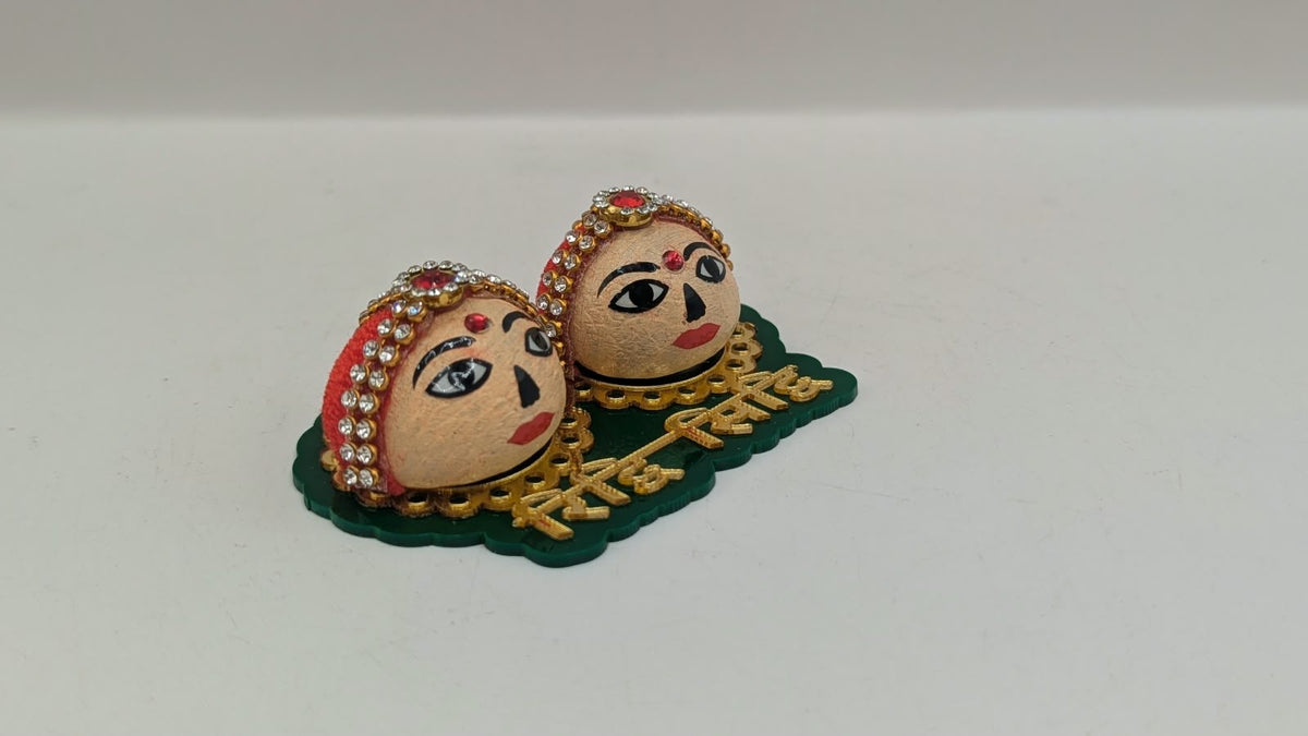 Riddhi Siddhi faces on green base, side view