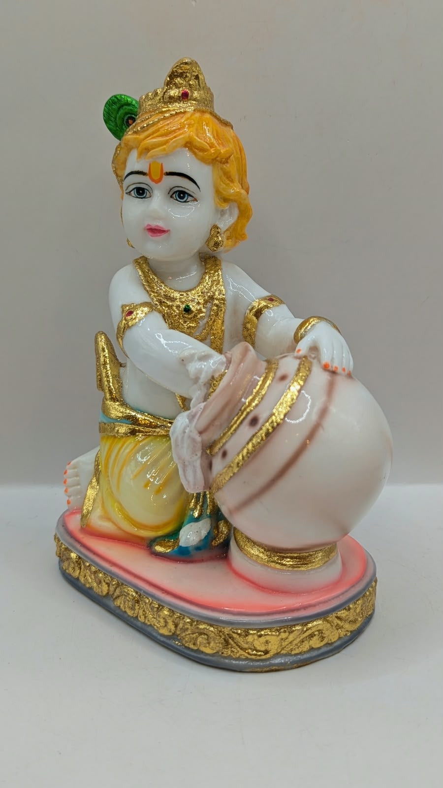 Baby Krishna statue with white pot, front view