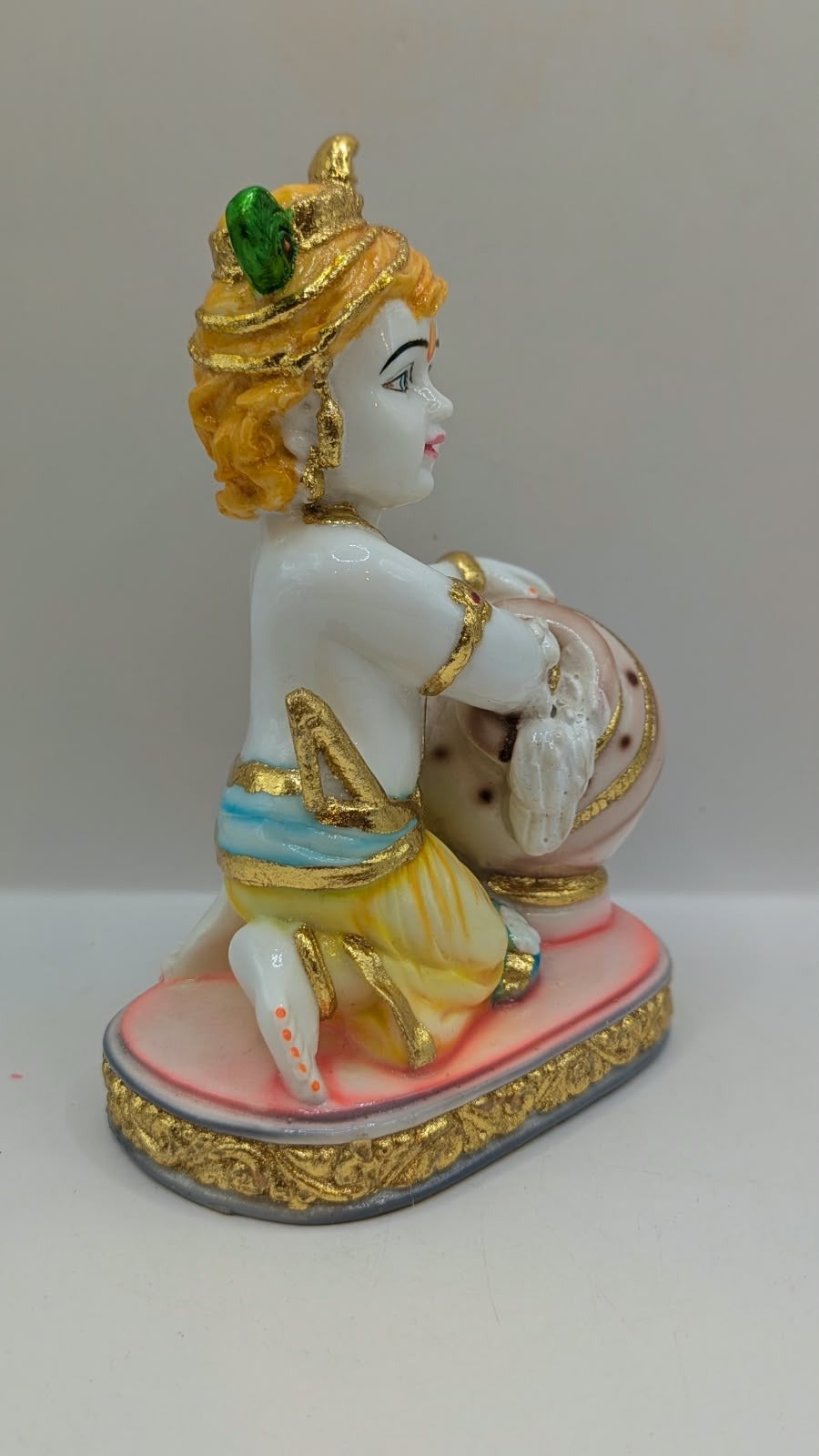 Baby Krishna statue with white pot, other side view