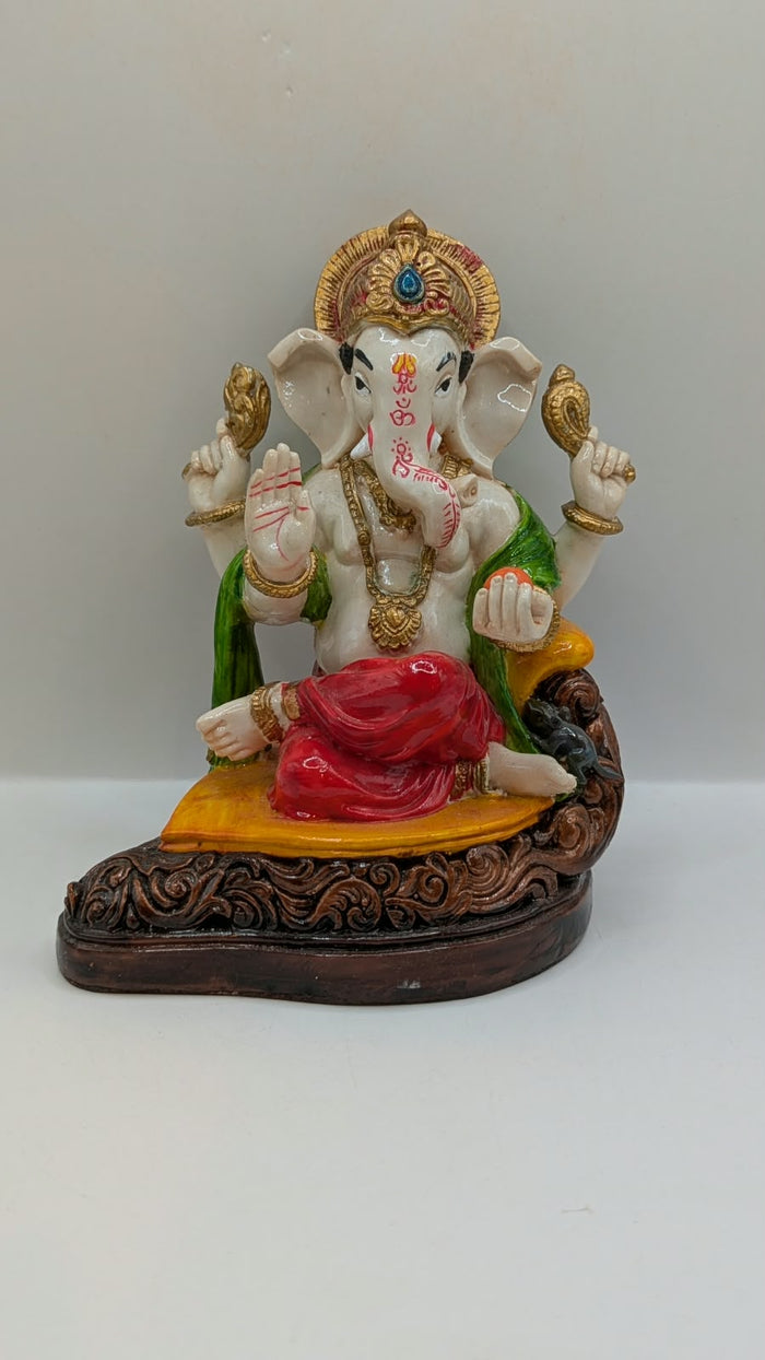 White Ganesh statue with red dhoti, front view