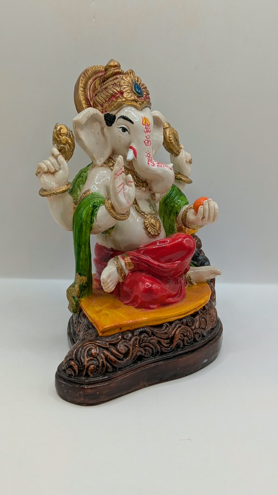 White Ganesh statue with red dhoti, side view