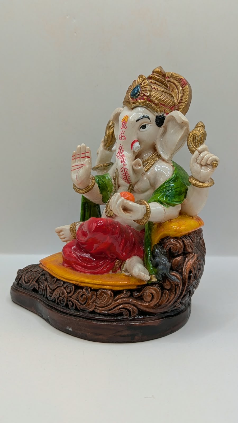 White Ganesh statue with red dhoti, other side view