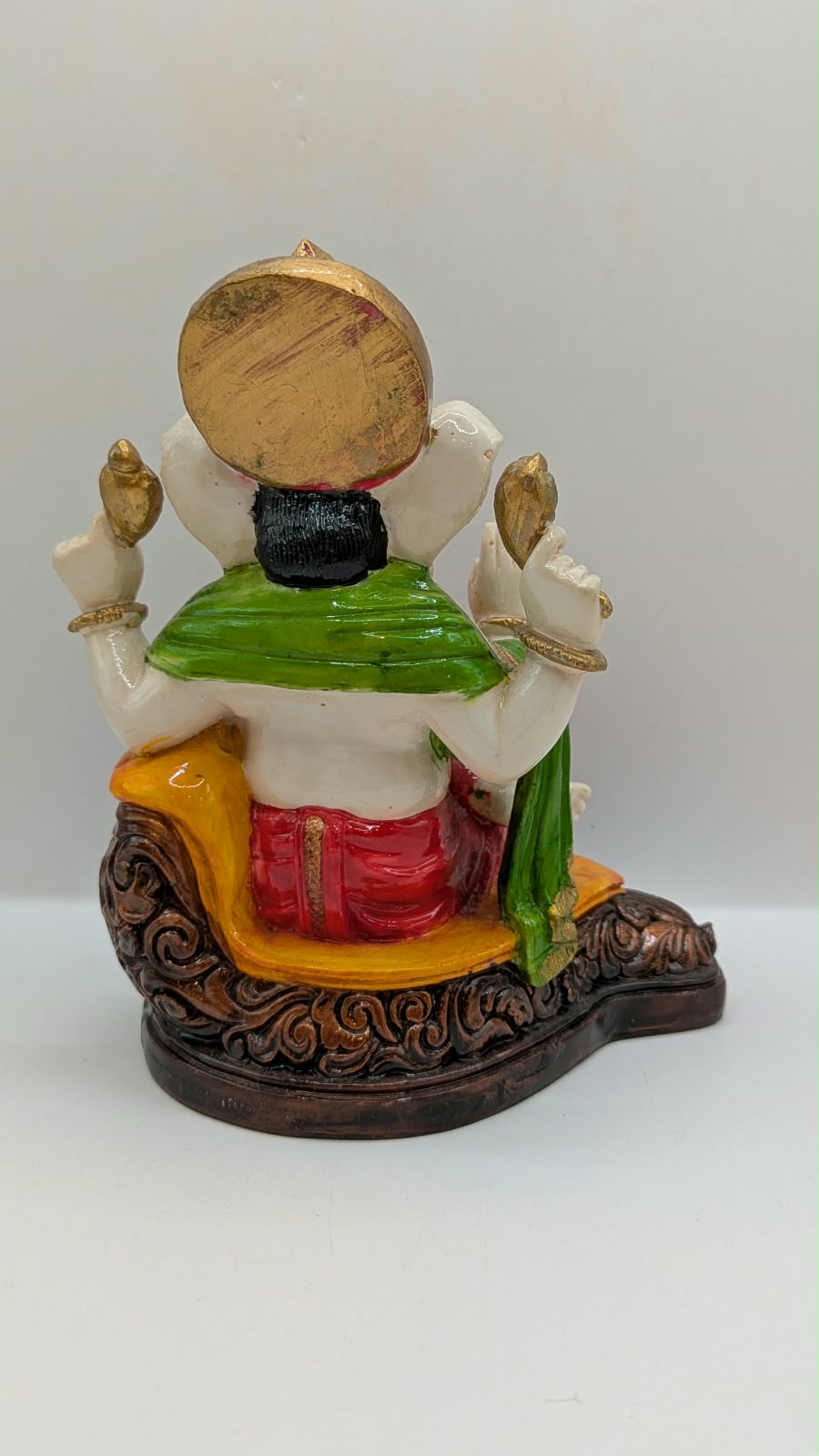 White Ganesh statue with red dhoti, back view