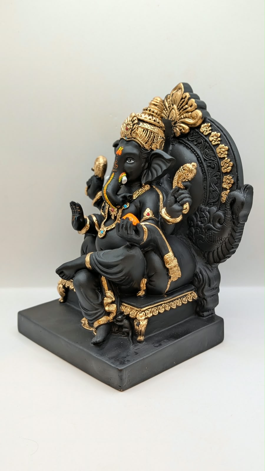 Black and gold Ganesh on throne, other side view