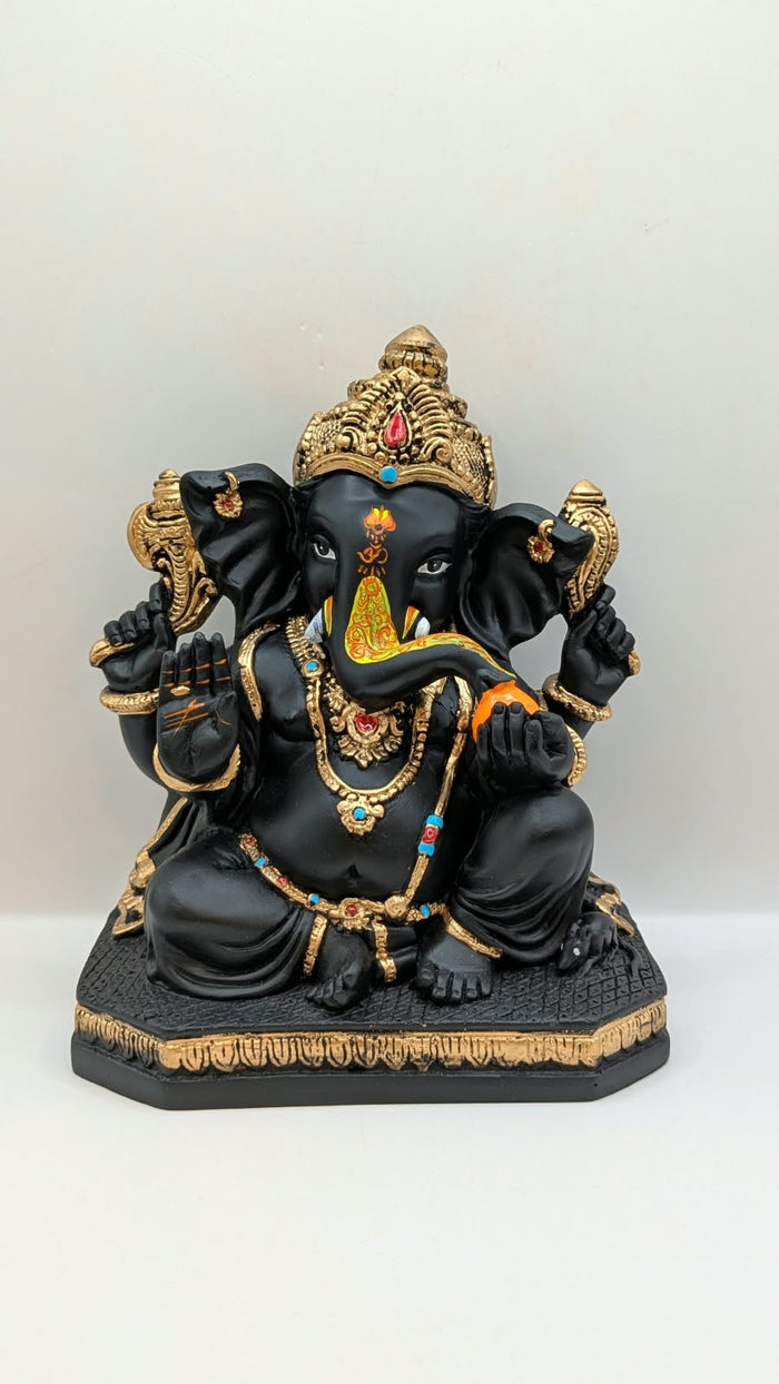 Black and gold Ganesh statue, front view