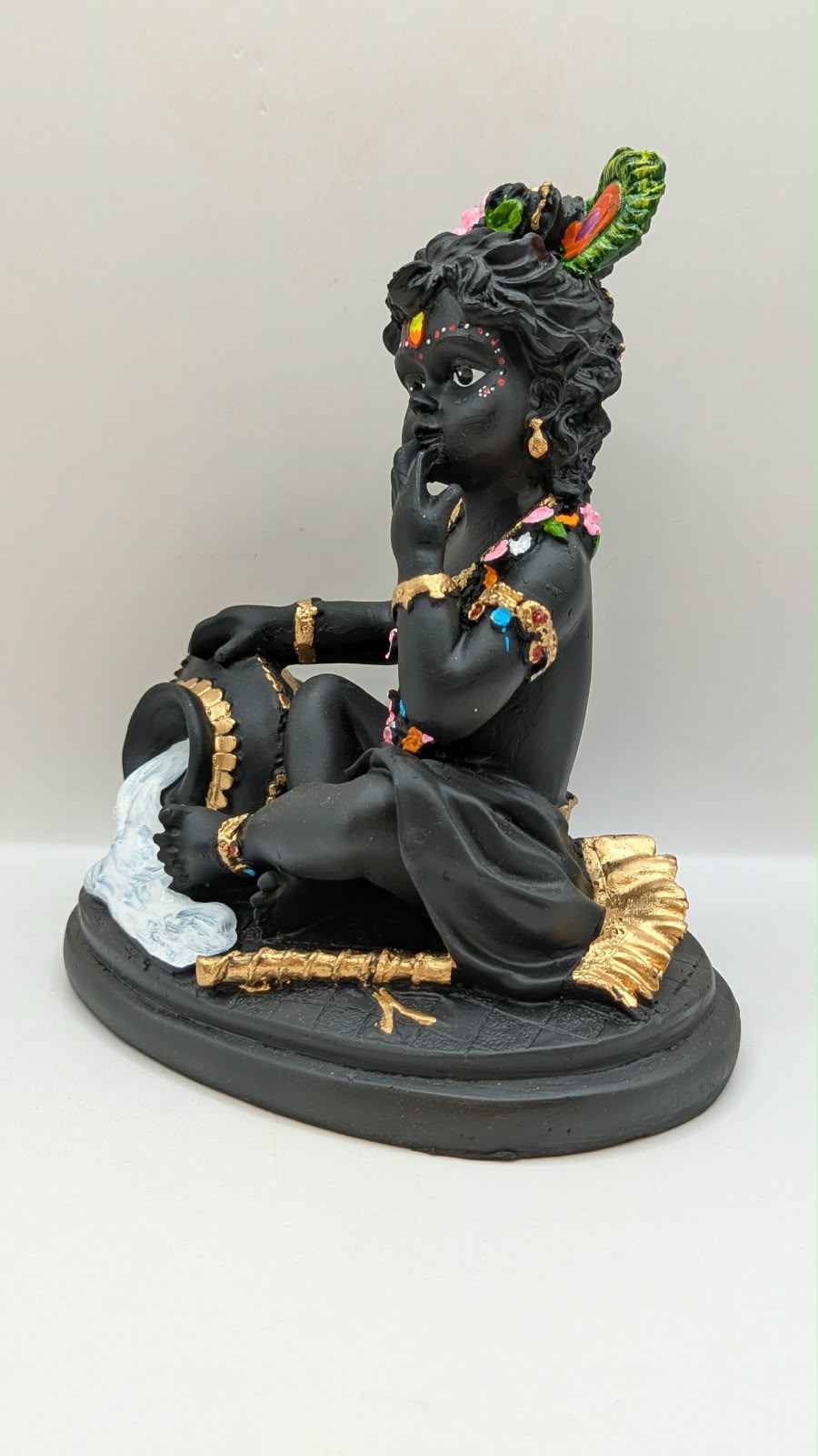 Black baby Krishna with butter pot, other side view