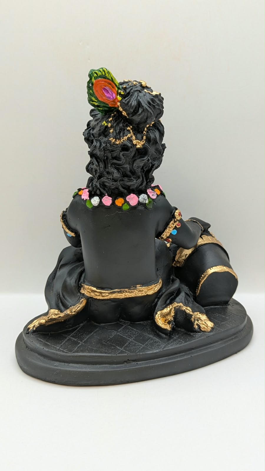 Black baby Krishna with butter pot, back view