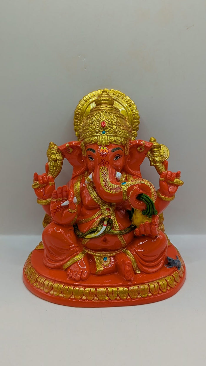 Orange and gold Ganesh statue, front view